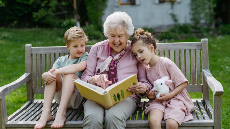 Illustration d'une grand-mère lisant un livre à ses petits-enfants